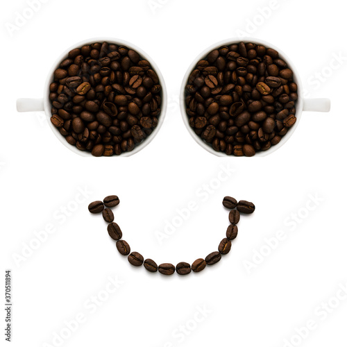 Image of a smiley face from the eyes of cups with a smile made of many coffee beans