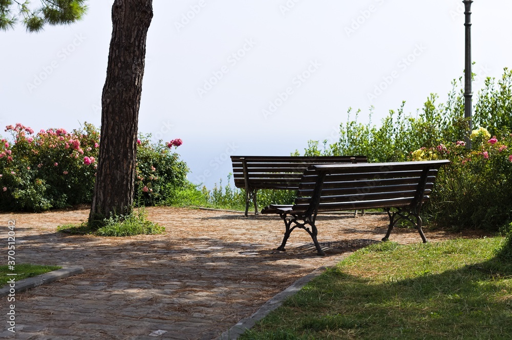 A garden with trees, plants, flowers and benches with a panoramic view above the Mediterranean sea (Pesaro, Italy, Europe) A garden with trees, plants, flowers and benches with a panoramic view above the Mediterranean sea (Pesaro, Italy, Europe)