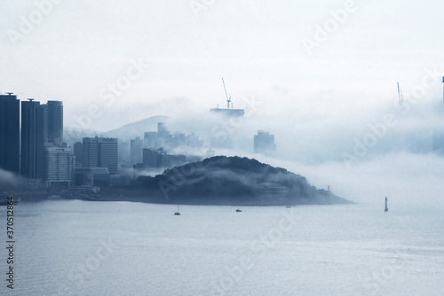 The beautiful beach and bay with thick mist blow from the sea to the land.