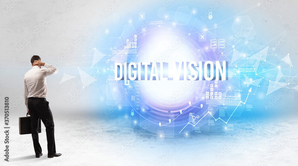 Rear view of a businessman standing in front of DIGITAL VISION inscription, modern technology concept Rear view of a businessman standing in front of DIGITAL VISION inscription, modern technology concept