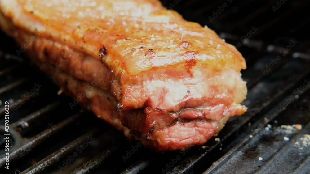 delicious smoked grilled pork belly meat on grill barbecue. close up shot. iron grill. pork ribs delicious smoked grilled pork belly meat on grill barbecue. close up shot. iron grill. pork ribs