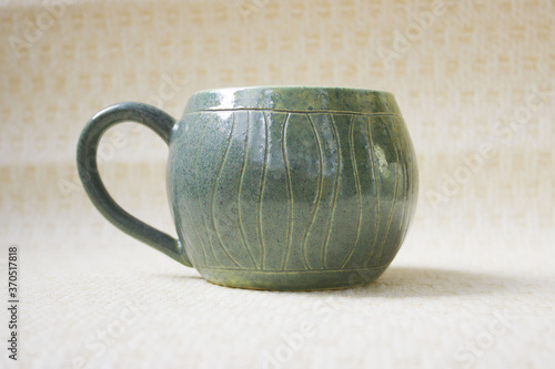 pot-bellied mug made of clay with a spectacular aqua glaze in the estuary. ceramics, handmade. reminder of the sea and travel.