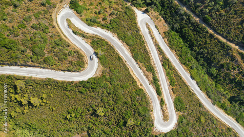 Aerial drone top down photo of snake serpentine road leading to mountain top