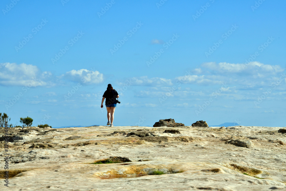 A woman walks on Lincoln's Rock at Wentworth Falls in the Blue Mountains west of Sydney, Australia