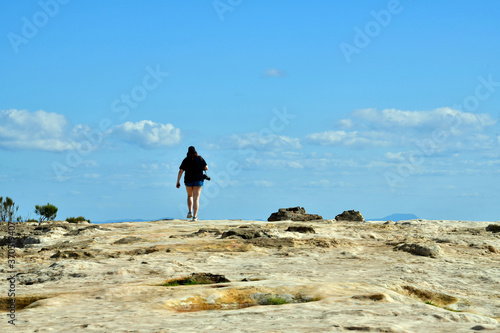 A woman walks on Lincoln s Rock at Wentworth Falls in the Blue Mountains west of Sydney  Australia