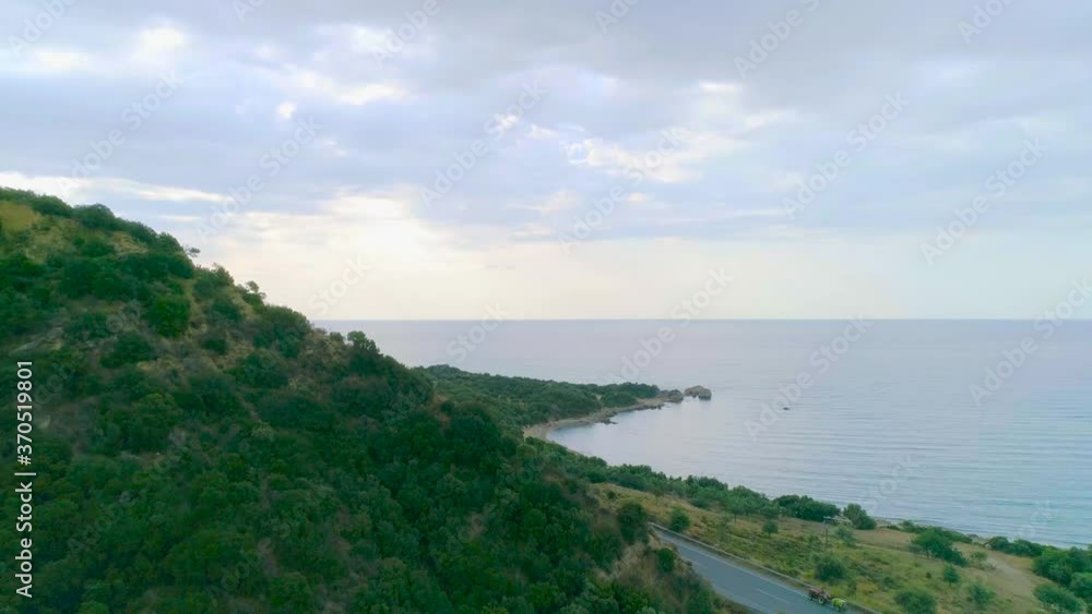 Interesting shot of green mountains and view of seascape and cloudy sky Interesting shot of green mountains and view of seascape and cloudy sky