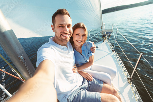 Couple Making Selfie Sailing On Yacht Enjoying Ride On Sailboat © Prostock-studio