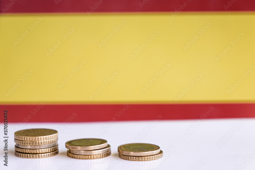 Euro coins at a white background economy europe with copy space and spanish flag