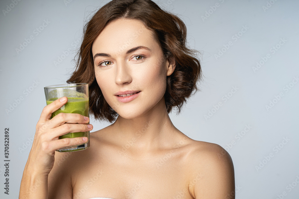 Beautiful young woman holding glass of smoothie Beautiful young woman holding glass of smoothie