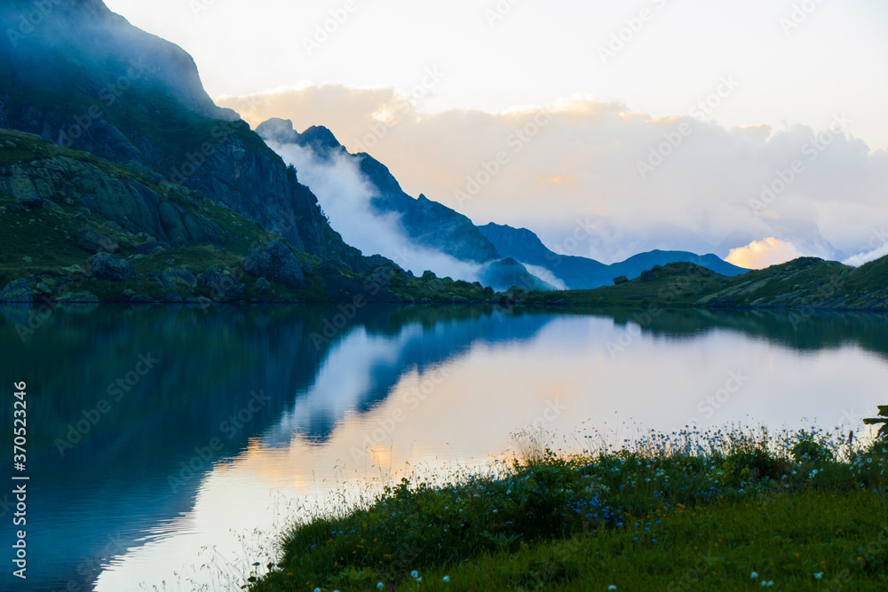 Mountain lake and fog, misty lake, amazing landscape and view of alpine lake Okhrotskhali in the Svaneti