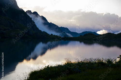 Mountain lake and fog, misty lake, amazing landscape and view of alpine lake Okhrotskhali in the Svaneti © taidundua