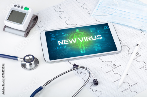 Tablet pc and doctor tools with NEW VIRUS inscription  coronavirus concept