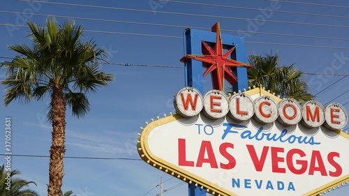 Welcome to fabulous Las Vegas retro neon sign in gambling tourist resort, USA. Iconic vintage banner as symbol of casino, games of chance, money playing and hazard betting. Lettering on signboard