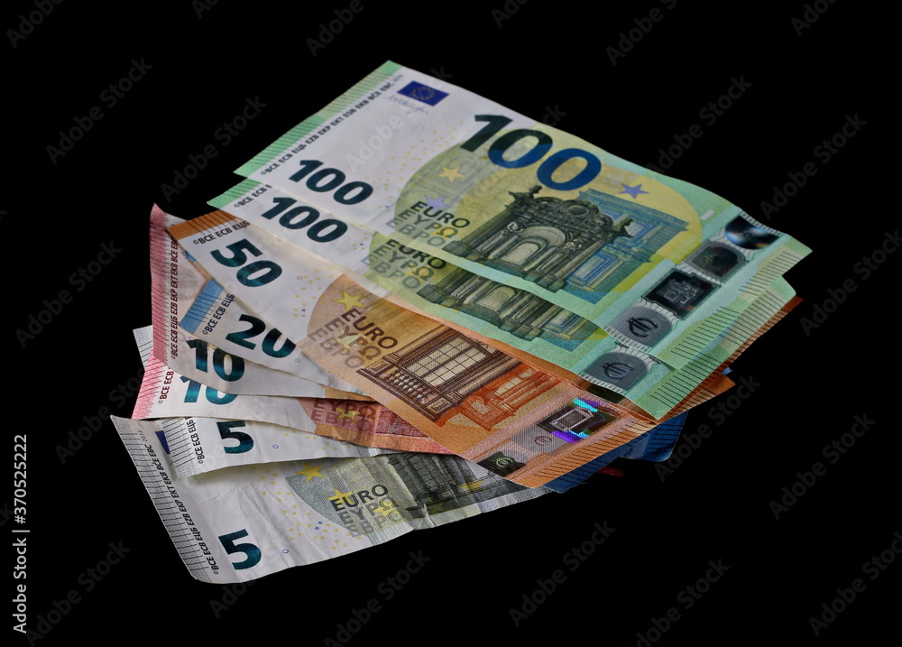 Euro paper cash money, banknotes, bills isolated on black background with clipping path Euro paper cash money, banknotes, bills isolated on black background with clipping path