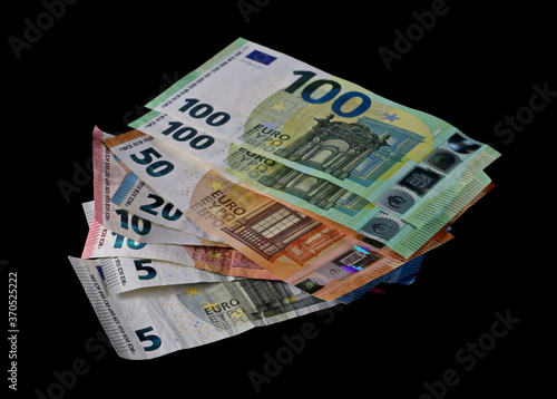 Euro paper cash money, banknotes, bills isolated on black background with clipping path