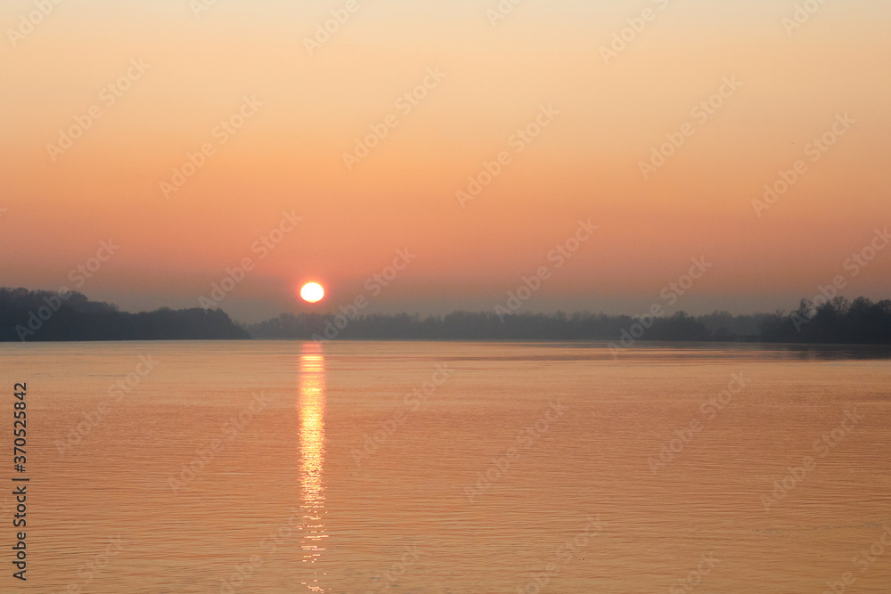 Orange Sunset over the Danube River in autumn Orange Sunset over the Danube River in autumn