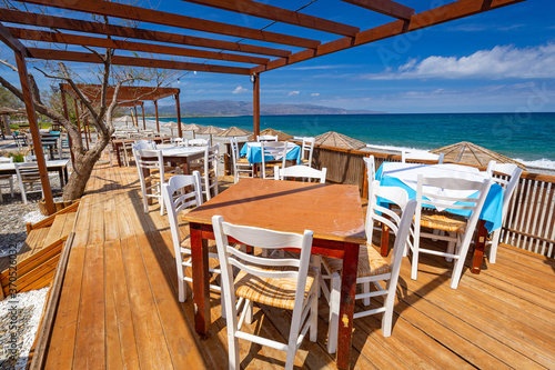 Empty restaurant tables at the Maleme beach on Crete  Greece