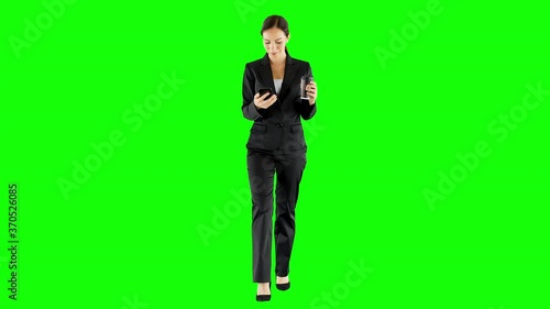 Joyful Businesswoman Walking And Using a Smartphone Green Screen