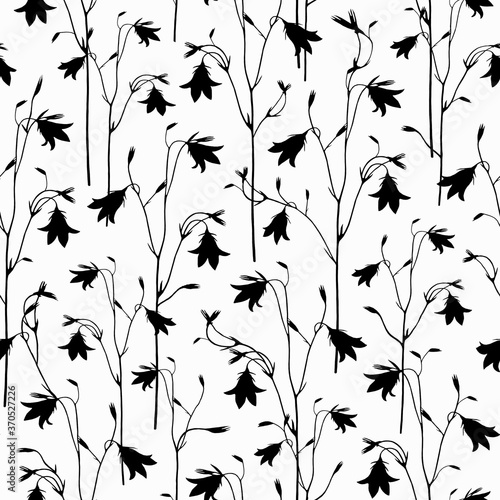 Elegant flowery seamless pattern for fabric, wrapping paper, wallpaper, design. Black silhouettes of bell flowers on a white background.