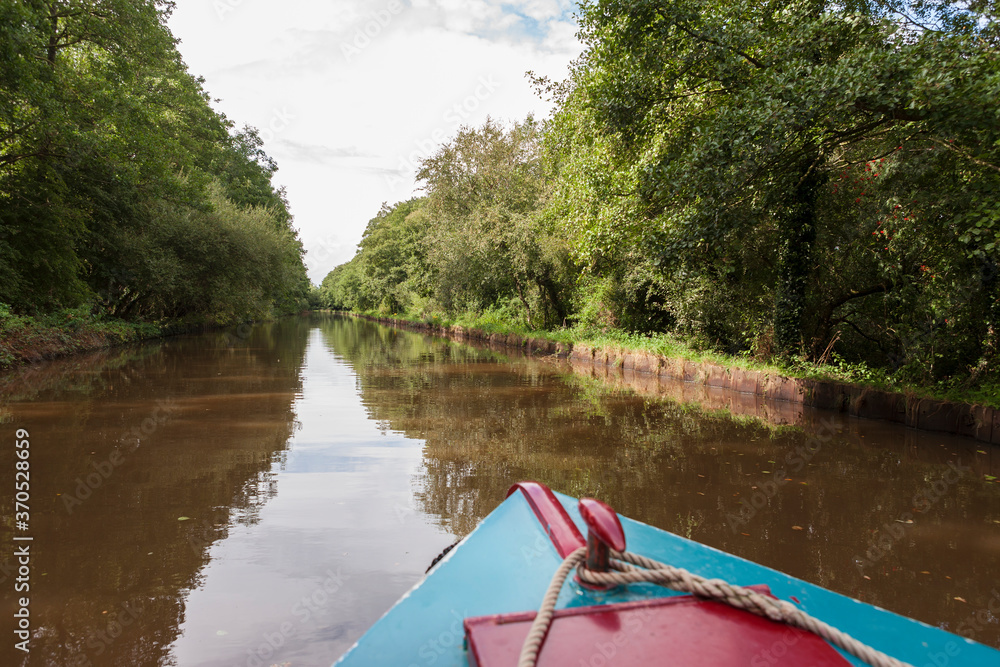 View from the bows of a narrowboat on a quiet stretch of the Llangollen Canal at Whixall Moss, on the England/Wales border