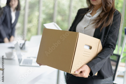 Business woman packing her belonging after resign or be fired from business company 