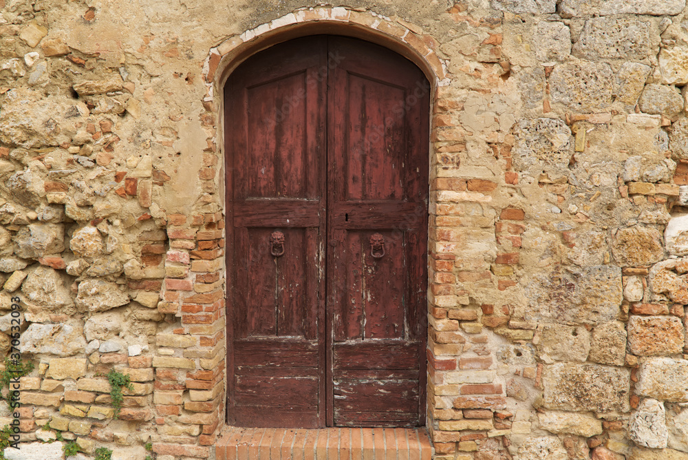 Ancient door of a house in the medieval center of San Gimignano