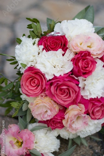 festive bouquet of pink-white with wedding rings © mtremerova