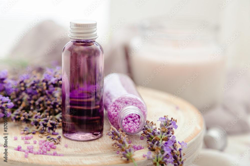 Set lavender bath cosmetics products in bottles with fresh lavender flowers candle soap bath beads. Lavender essential oil, natural spa products.Aromatherapy treatment Copy space Set lavender bath cosmetics products in bottles with fresh lavender flowers candle soap bath beads. Lavender essential oil, natural spa products.Aromatherapy treatment Copy space