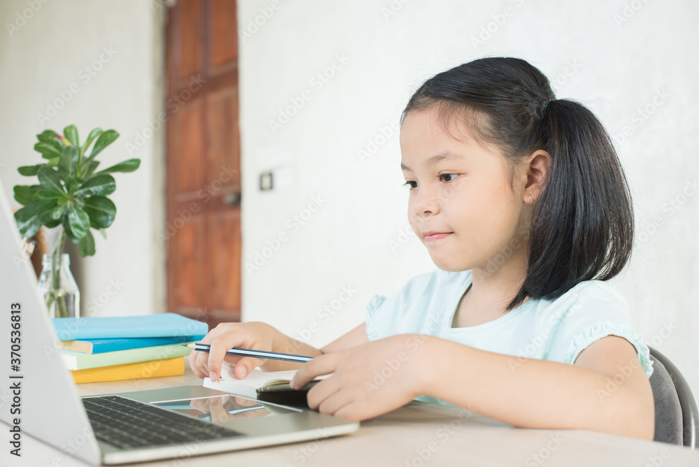 pretty stylish schoolgirl studying homework during online lesson at home, social distance during quarantine, self-isolation, online education concept, home school, study online video call teacher. pretty stylish schoolgirl studying homework during online lesson at home, social distance during quarantine, self-isolation, online education concept, home school, study online video call teacher.