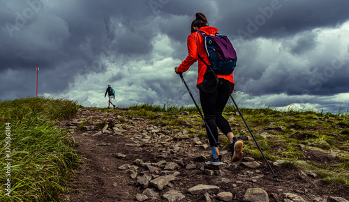 Girl hiking in the mountain. Bad weather in a mountains.