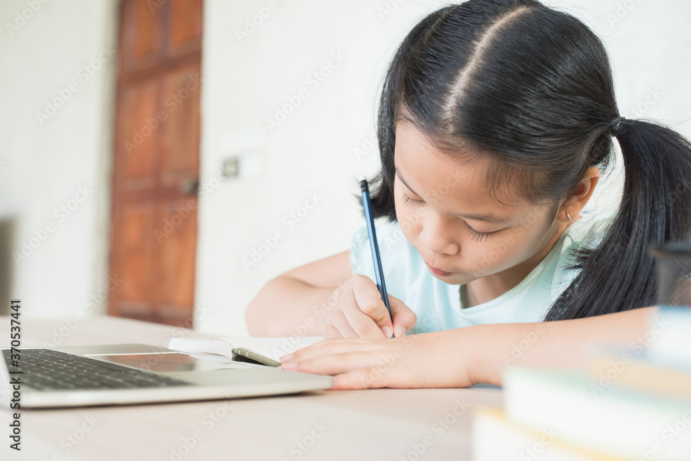 pretty stylish schoolgirl studying homework during online lesson at home, social distance during quarantine, self-isolation, online education concept, home school, study online video call teacher. pretty stylish schoolgirl studying homework during online lesson at home, social distance during quarantine, self-isolation, online education concept, home school, study online video call teacher.