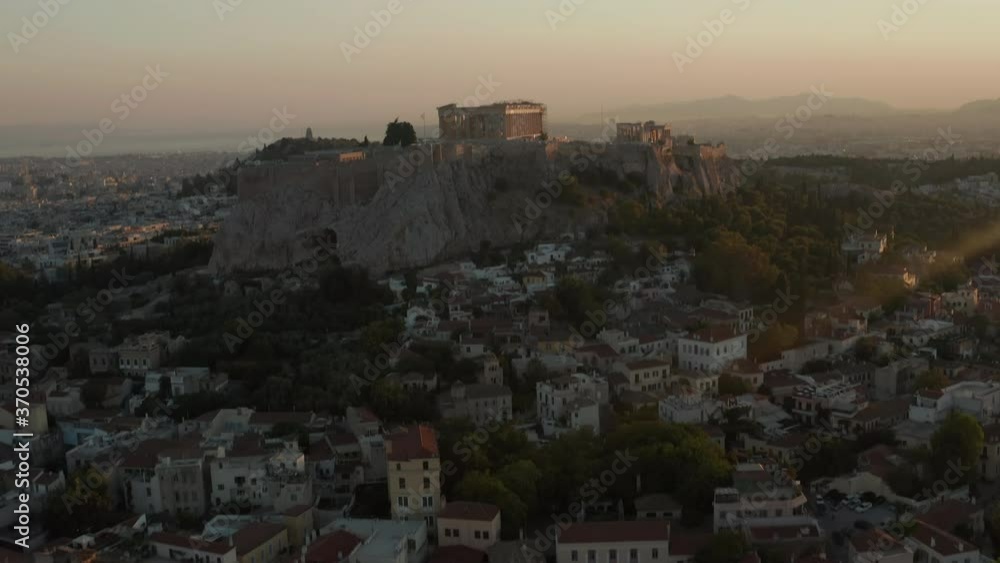 Aerial Pan Up on Mountain with Acropolis of Athens in Greece with sun flair in beautiful Golden Hour Aerial Pan Up on Mountain with Acropolis of Athens in Greece with sun flair in beautiful Golden Hour