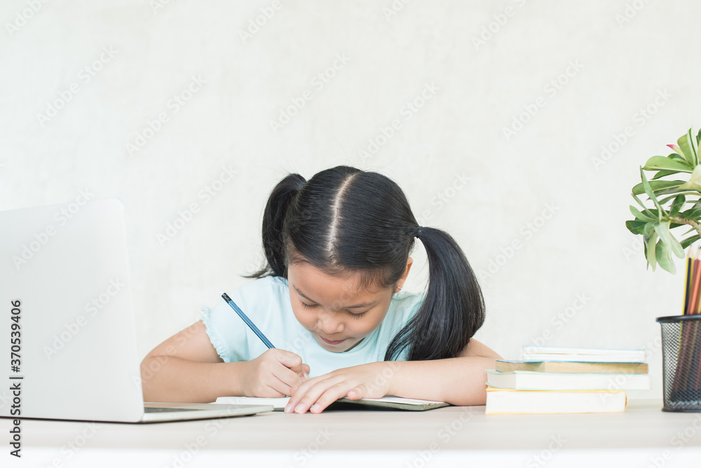 pretty stylish schoolgirl studying homework during online lesson at home, social distance during quarantine, self-isolation, online education concept, home school, study online video call teacher. pretty stylish schoolgirl studying homework during online lesson at home, social distance during quarantine, self-isolation, online education concept, home school, study online video call teacher.