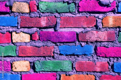 A wall of multi-colored bricks of ultra colors. photo