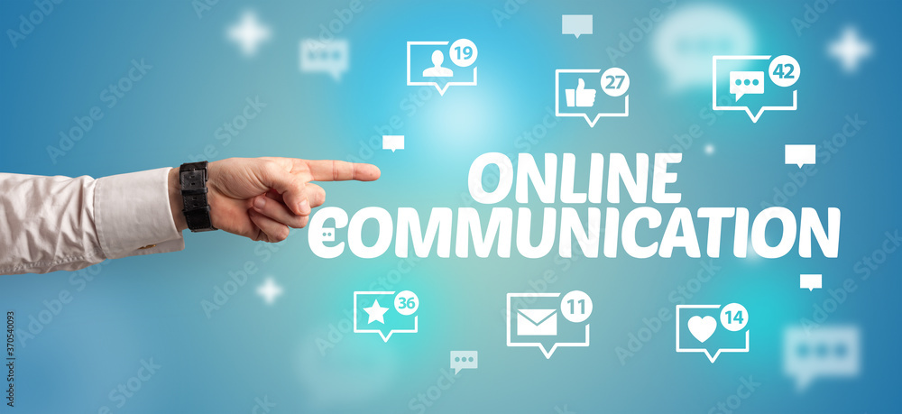 Close-Up of cropped hand pointing at ONLINE COMMUNICATION inscription, social networking concept Close-Up of cropped hand pointing at ONLINE COMMUNICATION inscription, social networking concept