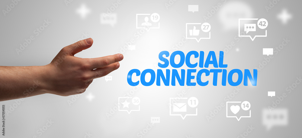 Close-Up of cropped hand pointing at SOCIAL CONNECTION inscription, social networking concept Close-Up of cropped hand pointing at SOCIAL CONNECTION inscription, social networking concept