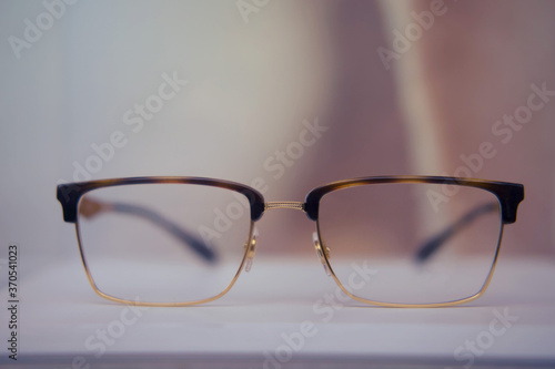 Square glasses with brown frames close up on a store shelf