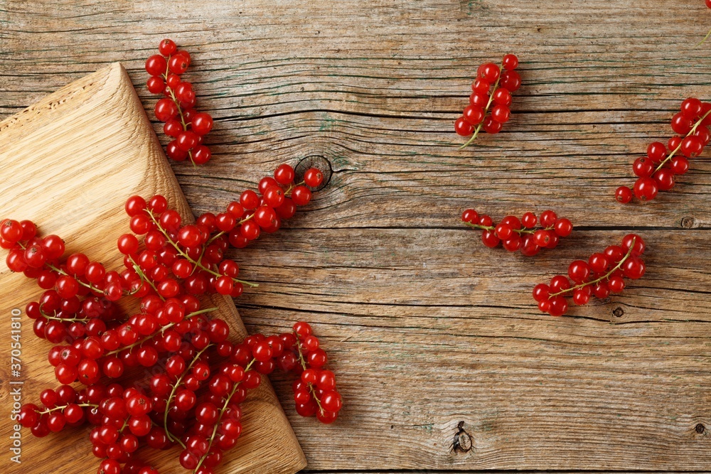 Fresh ripe red currants on rustic wooden background. Fresh ripe red currants on rustic wooden background.