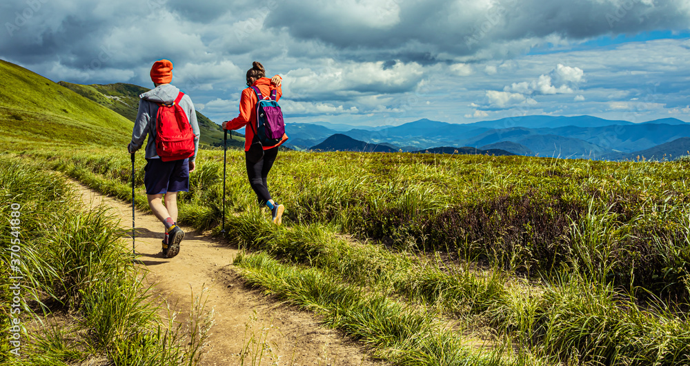 Hiking couple in the mountains. Mountain landscape on the summer. Mountain landscape in Poland Bieszczady.