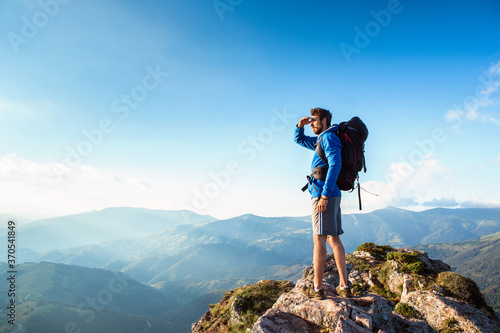 Hiker on the top of the mountain, landscape view