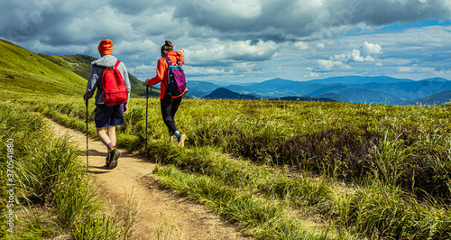 Fototapeta Naklejka Na Ścianę i Meble -  Hiking couple in the mountains. Mountain landscape on the summer. Mountain landscape in Poland Bieszczady.