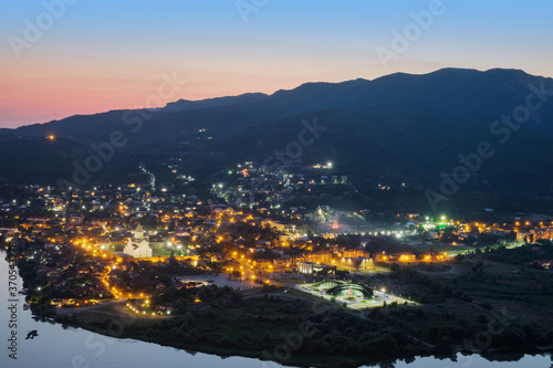 Aerial view of the ancient small town Mtskheta near the river at night © Luka