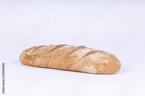 fresh rye loaf of bread on a white background