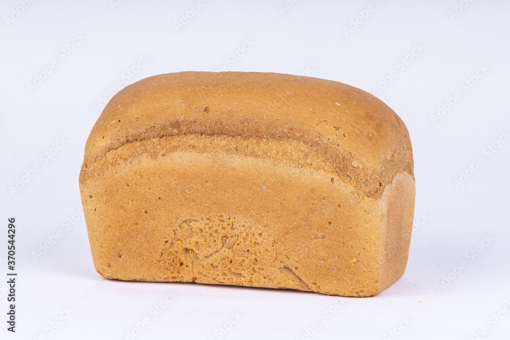 a loaf of fresh wheat bread on a white background