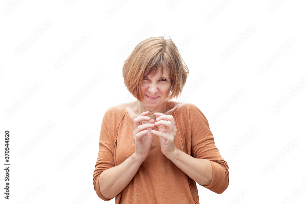 An adult redhead woman in casual clothes with a sly and ominously expression and steepled fingers. A cunning plan. Isolated on gray An adult redhead woman in casual clothes with a sly and ominously expression and steepled fingers. A cunning plan. Isolated on gray