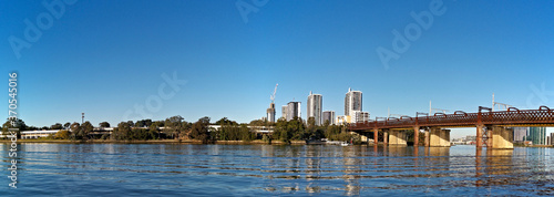 Beautiful panoramic view of a railway bridge across a river on a sunny day with deep blue sky, Parramatta river, Meadowbank, Sydney, New South Wales, Australia
