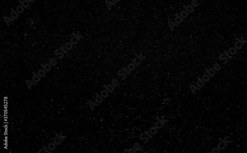 Black stone background with microcracks and fine texture.