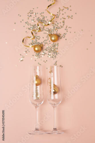 glasses and sparkles christmas concept on pink background.