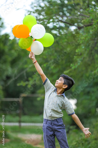 cute little indian boy with tri color balloons and celebrating Independence or Republic day of India