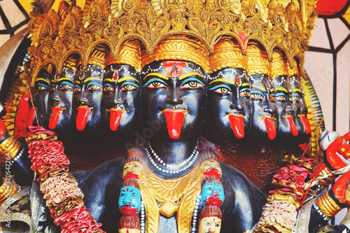 Tablou pe pânză The many-headed terrible black goddess Kali with tongues sticking out